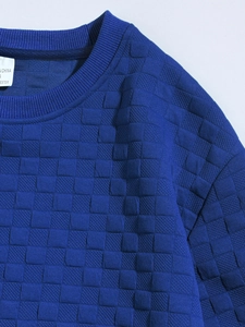 Detailed close-up of blue slim fit shirt featuring textured checkered knit fabric