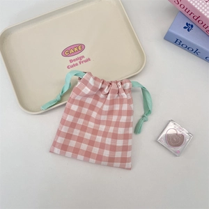 Pink and white checkered drawstring storage bag with mint green cords for cosmetics
