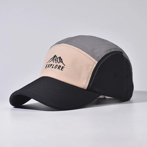 Detail of five-panel camper cap with grey mountain embroidery and explore text