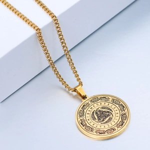 Detail shot of golden Viking rune pendant with Celtic knots on a polished Cuban chain