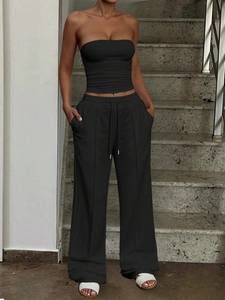 Detail of a minimalist black tube top and wide-leg trousers set for casual summer wear