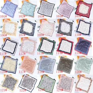 Collage of 25 small silk scarves with camellia and paisley prints in 5x5 grid
