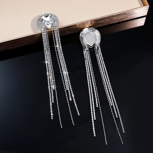 Macro shot of silver rhinestone long tassel earrings with sparkling pear-cut main stones