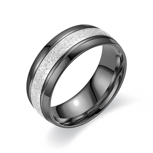Close-up of black matte titanium steel ring with a central silver glitter band