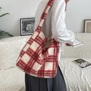 Detailed close-up of the red plaid faux fur tote bag showing soft fuzzy texture