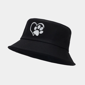 Detail of a black cotton bucket hat showing a white heart and paw print embroidery