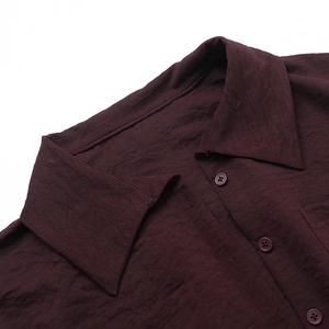 Detail of shirt collar and button placket in dark burgundy cotton-linen fabric texture