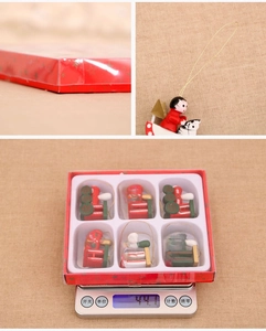 Close-up of 6 wooden Christmas train ornaments in a gift box weighing 44.7g