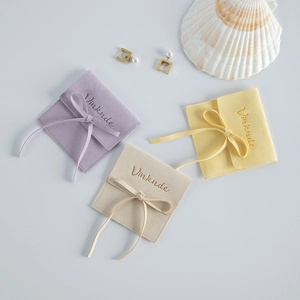 Elegant microfiber jewelry pouches in purple, beige and yellow with ribbon bows