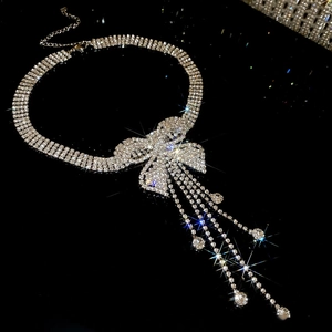 Macro shot of sparkling silver butterfly tassel necklace with pavé crystal fringe details