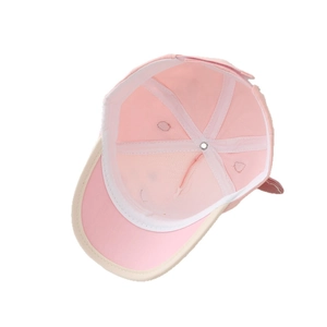 Pink and beige kids baseball cap showing internal cotton structure and breathable eyelets