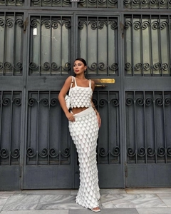 Detail of white two-piece knit set with unique 3D scale texture and slim mermaid skirt