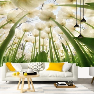 Detail of 3D forest wall tapestry showing white tulips under a blue sky in a living room