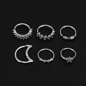 Detail set of 6 silver nose rings featuring moon, star, and leaf zircon designs
