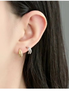 Close-up of gold and silver S925 sterling silver hoop earrings with micro-set zircon