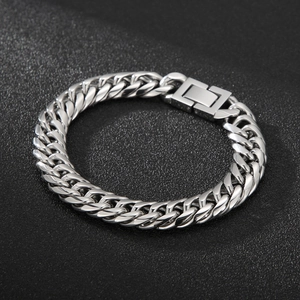Close-up of a high-polish silver Cuban link chain with a unique square jewelry clasp