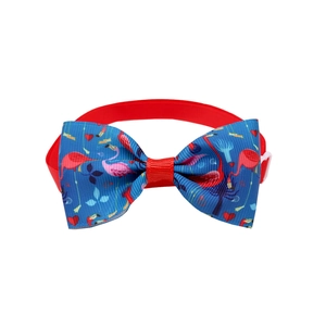 Detail of adjustable pet bowtie with pink flamingo prints on a blue fabric base