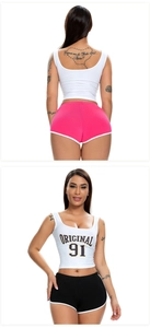 Detail of crop top and contrast binding sports shorts set for women in studio lighting