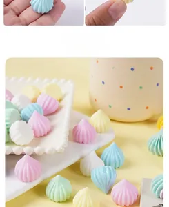 Macro detail of colorful resin meringue charms with fine vertical stripes for DIY crafts
