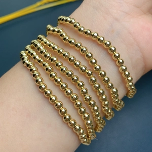 Multilayer gold beaded stretch bracelet for women featuring minimalist cross and heart charms