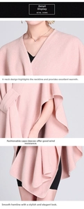 Detail of pink knitted poncho showing the V-neck, cape sleeves and smooth hemline