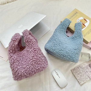 Fuzzy lamb wool handbags in light purple and sky blue displayed with lifestyle props
