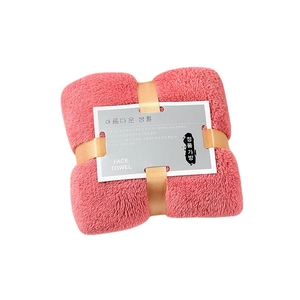 Pink coral fleece face towel with golden ribbon bow tie and white gift packaging