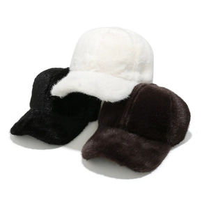 Detailed close-up of plush faux fur texture on white, black, and brown baseball caps