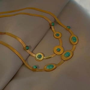 Double-layered golden snake chain necklace featuring turquoise stone pendants for women