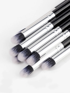 Detailed view of dense black and white synthetic fiber bristles on professional eye brushes