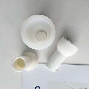 Detailed view of three white silicone molds for DIY striped long pillar candles