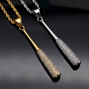 Detailed macro shot of gold and silver iced out baseball bat pendants on rope chains