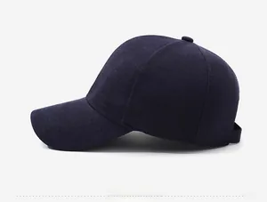 Close-up of a navy blue baseball cap featuring a premium metallic side badge detail