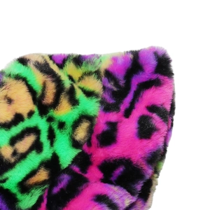 Macro detail of plush faux fur texture with vibrant neon leopard print in multiple colors