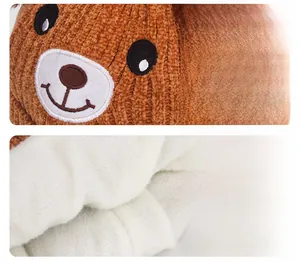 Detail of brown baby knit hat featuring bear design and thick warm fleece lining