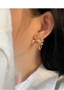 Detailed close-up of pink petal flower stud earrings with sparkling cubic zirconia accents