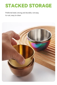 Stacked storage display of colorful stainless steel sauce bowls on a wooden tray