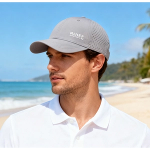 Detail of dark grey baseball cap with laser-cut side vents for breathable outdoor wear
