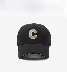 Close-up of black mesh cap with khaki embroidered C letter and SPORT logo on the brim