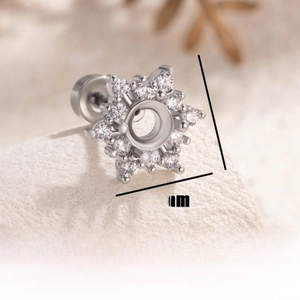 Macro detail of snowflake-shaped surgical steel earring setting with cubic zirconia