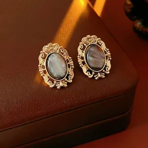 Vintage oval resin earrings set with golden hollow carving in baroque style jewelry