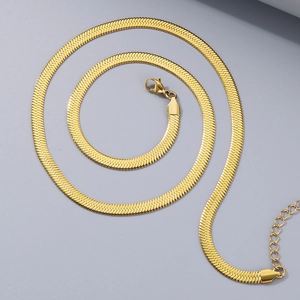 Detail of a golden herringbone chain with lobster clasp and extension link texture