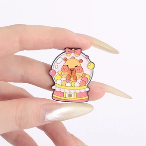 Close-up of a pink capybara gacha machine enamel pin with colorful details and metal finish