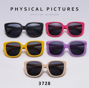 Flat lay of oversized square sunglasses in black, pink, yellow, purple, and beige