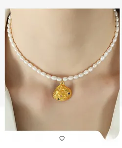 Detailed view of natural freshwater pearl necklace with shell pendant and colorful gemstones