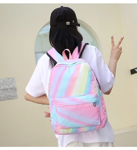 Rainbow gradient backpack worn by model, showing large capacity and vibrant casual style