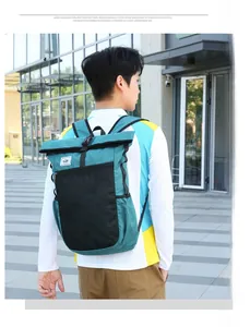Waterproof travel backpack detail showing blue and black roll-top and zipper closure