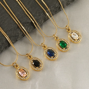 Detail of 18K gold necklaces featuring oval zircon pendants in five vibrant gemstone colors