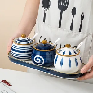 Hand-painted blue and white ceramic seasoning jar set with lids, spoons, and tray