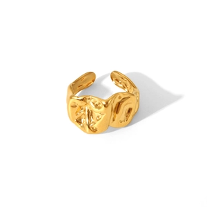 Detailed view of the golden irregular lava texture on an adjustable stainless steel ring